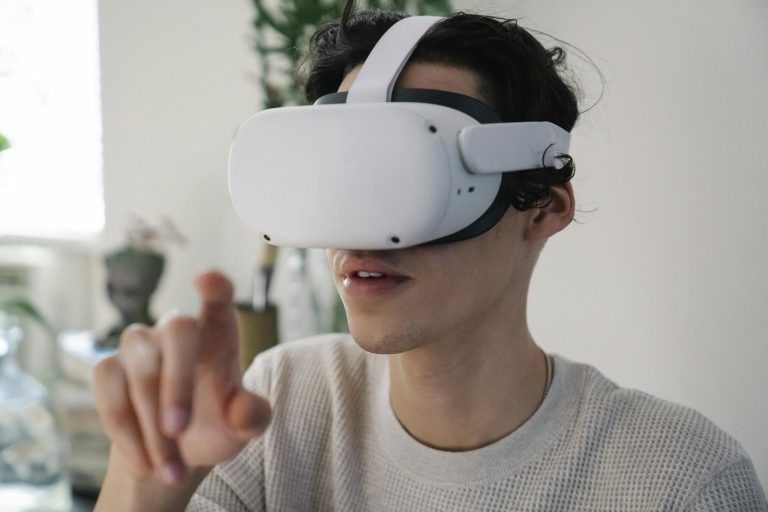 Close-up of a young man immersed in a virtual reality experience indoors using a VR headset.