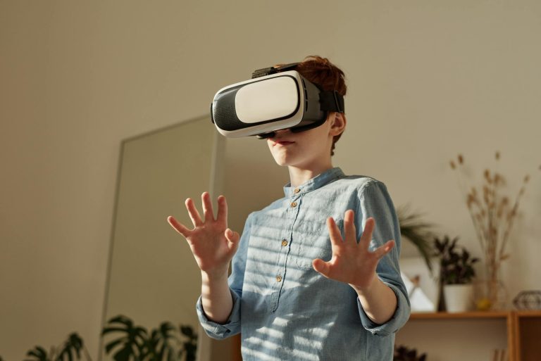 Young boy in blue shirt using VR headset indoors for gaming fun.